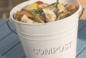 a compost crock is filled up with kitchen food